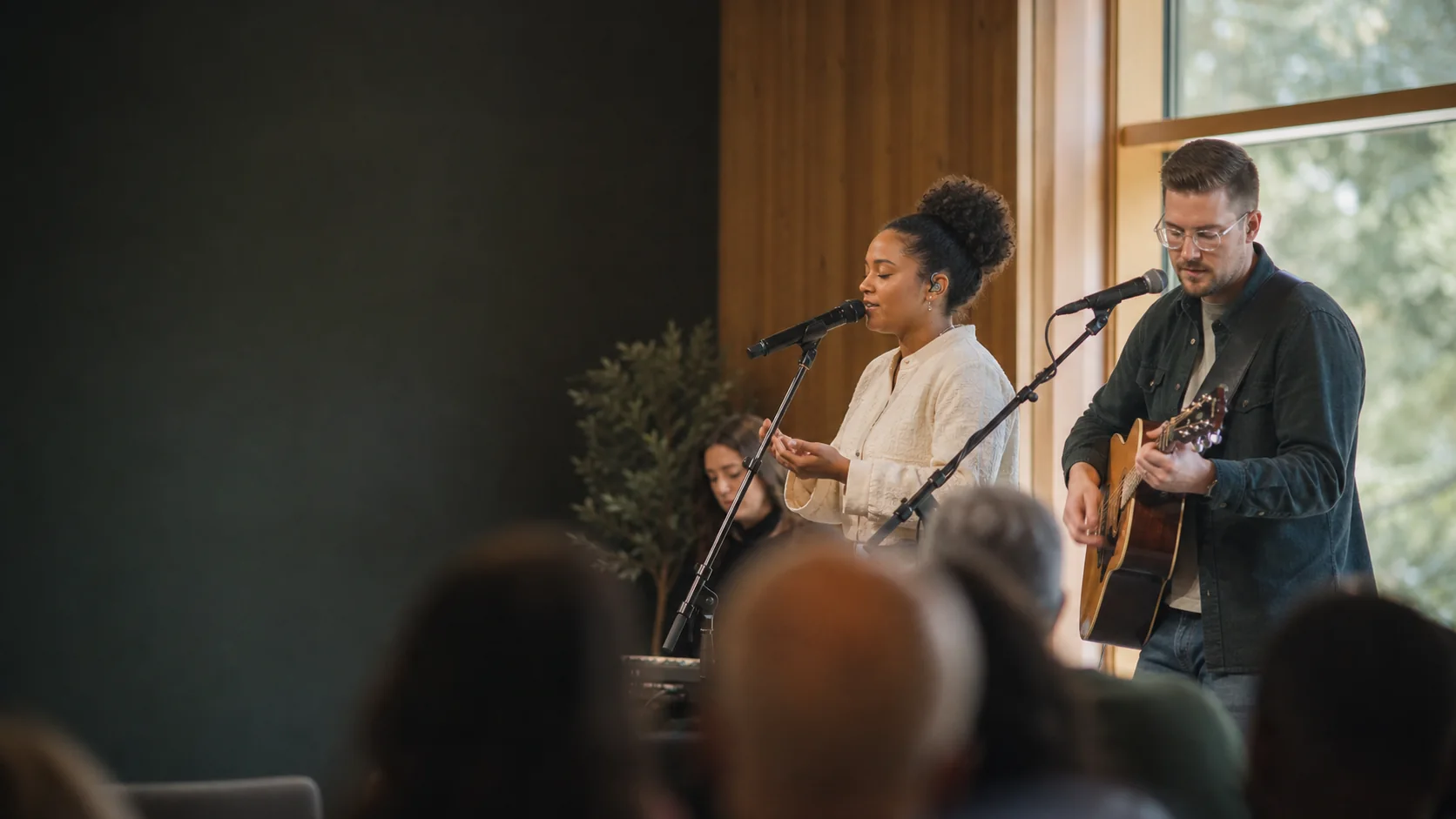 Worship leaders singing together during a Sunday gathering